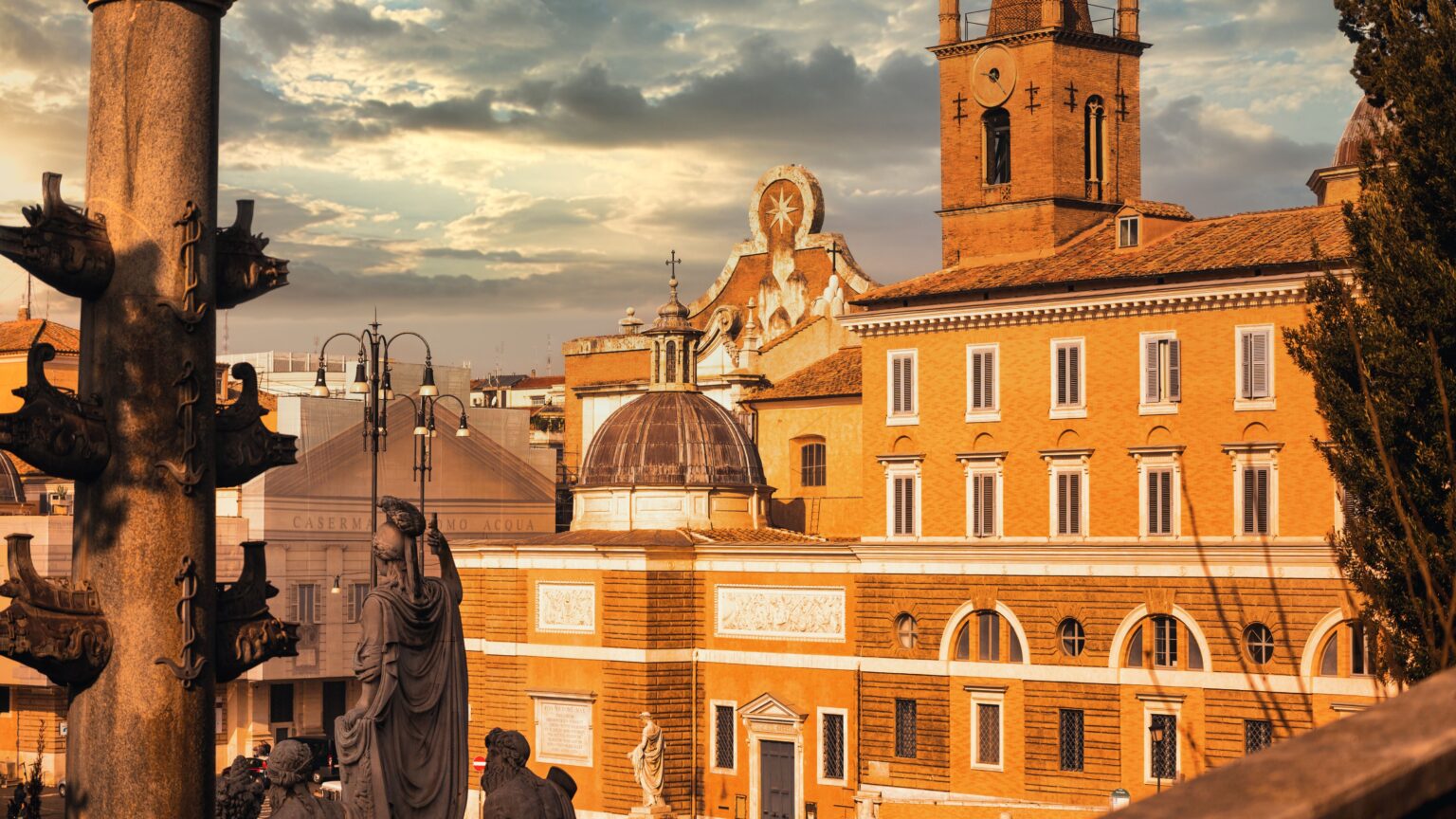 A sceni view of statues in front of a majestic building under a cloudy sky in Rome, Italy
